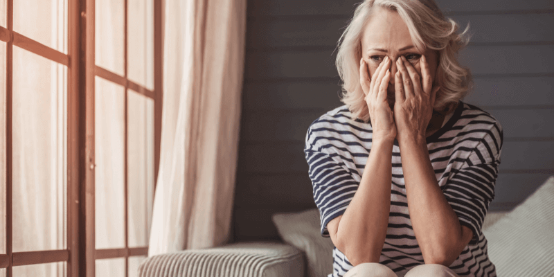 When you're telling yourself "he doesn't want me sexually", you can feel worthless, unattractive, and scared. 

Image: woman sitting on the edge of a bed looking sad.